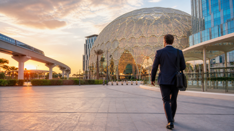 Business traveller arriving at Expo City Dubai at sunset